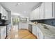 Bright kitchen with granite counters, stainless appliances, and hardwood floors at 4210 Brynwood Ave, Durham, NC 27713