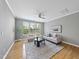 Bright living room with modern furniture, a ceiling fan, and large windows allowing ample natural light at 4210 Brynwood Ave, Durham, NC 27713