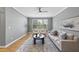 Bright living room featuring hardwood floors, modern ceiling fan, and comfortable seating at 4210 Brynwood Ave, Durham, NC 27713