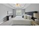 Tranquil main bedroom with tray ceiling, ceiling fan, and large windows for natural light at 4210 Brynwood Ave, Durham, NC 27713