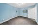 Bright room with blue walls, carpet, and natural light, perfect for customization at 4210 Brynwood Ave, Durham, NC 27713