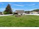 Large backyard with green grass, surrounded by a white fence and various seating arrangements perfect for entertainment at 4304 S Greg Allen Way, Oxford, NC 27565