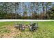 Spacious backyard featuring a fire pit with Adirondack chairs, perfect for outdoor gatherings and relaxation at 4304 S Greg Allen Way, Oxford, NC 27565