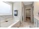 Modern bathroom featuring a large soaking tub, marble tile surround, and neutral paint at 4304 S Greg Allen Way, Oxford, NC 27565
