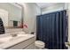 Bathroom featuring a vanity with a sink, toilet, and a shower with a blue curtain at 4304 S Greg Allen Way, Oxford, NC 27565