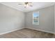 Neutral bedroom with carpet, ceiling fan, a window bringing in plenty of natural light, and white trim at 4304 S Greg Allen Way, Oxford, NC 27565