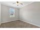 Neutral bedroom with a ceiling fan, carpet, a window and white trim at 4304 S Greg Allen Way, Oxford, NC 27565