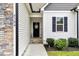 Up-close view of the front door shows stone accents and a welcoming wreath at 4304 S Greg Allen Way, Oxford, NC 27565