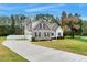 Well maintained two-story home features a large driveway, fenced in yard, and green lawn at 4304 S Greg Allen Way, Oxford, NC 27565