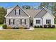 Charming two-story home with stone and board and batten siding and a well-manicured lawn at 4304 S Greg Allen Way, Oxford, NC 27565