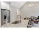 Stylish kitchen island with granite countertop, stainless steel refrigerator, and open view to living room at 4304 S Greg Allen Way, Oxford, NC 27565