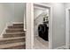 View of the stairs to the landing and the laundry room featuring modern washer and dryer at 4304 S Greg Allen Way, Oxford, NC 27565
