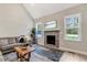 Inviting living room featuring a stone fireplace, hardwood floors, and ample natural light at 4304 S Greg Allen Way, Oxford, NC 27565