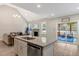 Bright living area with kitchen island, fireplace, access to a porch, and comfortable seating at 4304 S Greg Allen Way, Oxford, NC 27565