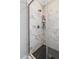 Glass shower enclosure featuring tile walls, a rainfall shower head, and built-in shelving at 4304 S Greg Allen Way, Oxford, NC 27565