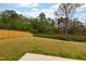 Spacious backyard with lush green grass, a wooden fence, and mature trees at 501 Willard Woods Dr, Wendell, NC 27591