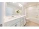 Bathroom featuring double sinks, a large mirror, and a bathtub at 501 Willard Woods Dr, Wendell, NC 27591