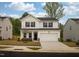 Charming two-story home featuring a two-car garage and stone accents at 501 Willard Woods Dr, Wendell, NC 27591