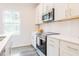 Modern kitchen featuring stainless steel appliances and stylish white cabinetry at 501 Willard Woods Dr, Wendell, NC 27591