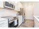 Contemporary kitchen featuring white cabinets, stainless steel appliances, and modern backsplash at 501 Willard Woods Dr, Wendell, NC 27591