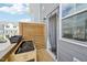 Private balcony with a wooden planter box, exterior siding, and view of neighboring townhomes at 5217 Invention Way, Raleigh, NC 27616