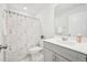 Bright bathroom featuring a gray vanity, nautical-themed shower curtain, and neutral wall paint at 5217 Invention Way, Raleigh, NC 27616