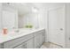 Bright bathroom with a double sink vanity, light gray cabinets, and a large mirror at 5217 Invention Way, Raleigh, NC 27616