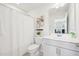 Bathroom with white shower curtain and single sink vanity at 5217 Invention Way, Raleigh, NC 27616