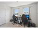 Bedroom featuring two desks, two chairs, and two windows with curtains at 5217 Invention Way, Raleigh, NC 27616