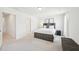 A bedroom with a large window, soft carpet, and a bed with built-in storage at 5217 Invention Way, Raleigh, NC 27616
