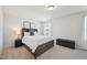 A bright bedroom with a large window, soft carpet, and a bed with built-in storage at 5217 Invention Way, Raleigh, NC 27616