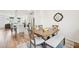 A modern dining room with a wooden table and bench, next to a stylish, open kitchen at 5217 Invention Way, Raleigh, NC 27616
