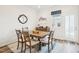 A dining room with a wooden table and chairs, next to an open window at 5217 Invention Way, Raleigh, NC 27616