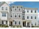 New townhome exterior showcasing a craftsman style with varied siding textures and stone accents at 5217 Invention Way, Raleigh, NC 27616