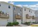 Row of townhomes featuring private balconies over attached garages and well manicured landscaping at 5217 Invention Way, Raleigh, NC 27616