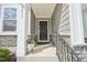 Close-up of the front entrance, complemented by a decorative wreath and stone detailing at 5217 Invention Way, Raleigh, NC 27616