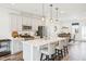 An airy kitchen with stainless steel appliances, white cabinets, and a quartz countertop island with seating at 5217 Invention Way, Raleigh, NC 27616