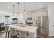 Bright, modern kitchen features stainless steel appliances, a large island, and stylish pendant lighting at 5217 Invention Way, Raleigh, NC 27616