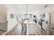 The open-concept kitchen is equipped with stainless steel appliances and hardwood floors at 5217 Invention Way, Raleigh, NC 27616