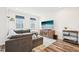 Well-lit living room with comfortable seating, a modern TV, and hardwood floors at 5217 Invention Way, Raleigh, NC 27616