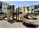 Community playground including a climbing wall and slides, surrounded by mature landscaping at 5217 Invention Way, Raleigh, NC 27616