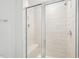 Tiled shower with glass doors and a built-in bench at 5217 Invention Way, Raleigh, NC 27616