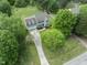 Aerial view of a home surrounded by lush greenery, mature trees and a well-manicured lawn at 5424 Westminster Ln, Fuquay Varina, NC 27526