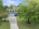 Charming two-story home with a two-car garage, expansive green lawn, and mature trees at 5424 Westminster Ln, Fuquay Varina, NC 27526