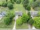 Aerial view showcasing two story home surrounded by mature trees and a lush green lawn in a neighborhood at 5424 Westminster Ln, Fuquay Varina, NC 27526