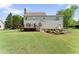 Backyard featuring a deck, manicured landscaping, and lush green grass at 5424 Westminster Ln, Fuquay Varina, NC 27526