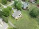 Aerial shot of home featuring a deck and stone fire pit in the backyard, surrounded by a lush lawn at 5424 Westminster Ln, Fuquay Varina, NC 27526