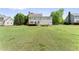 Expansive backyard with lush green grass, a spacious deck, and manicured landscaping at 5424 Westminster Ln, Fuquay Varina, NC 27526