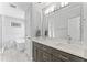 Bright bathroom featuring double sinks, a soaking tub, and a glass door shower at 5424 Westminster Ln, Fuquay Varina, NC 27526