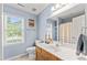 Blue bathroom with white sink, mirror, toilet, and window at 5424 Westminster Ln, Fuquay Varina, NC 27526